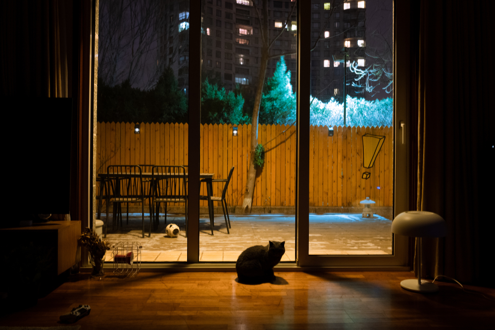 Illuminated traditional courtyard at night with string lights and stone archways